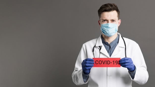 doctor-holding-covid-19-card-copy-space_23-2148445989